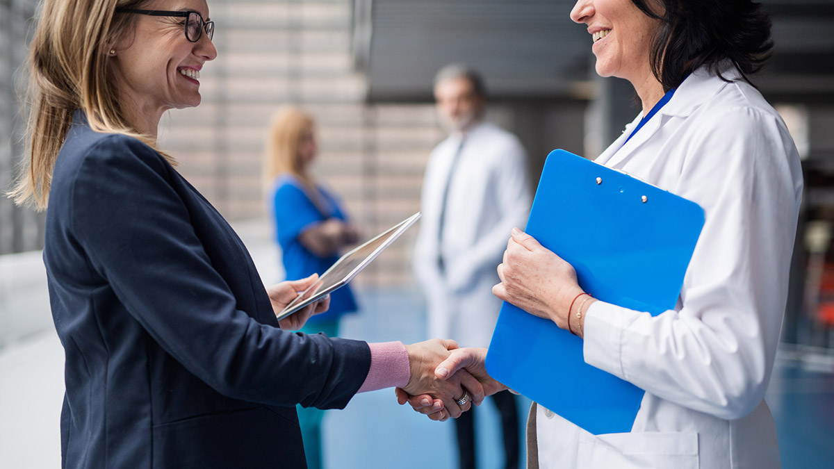 Doctor shaking a business associate's hand