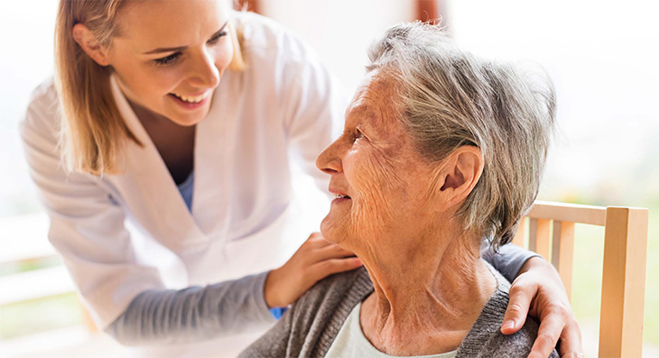 Healthcare professional helping a patient